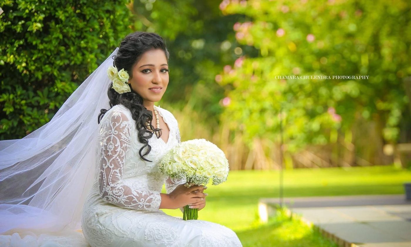 Bride seated with her bouquet before the ceremony