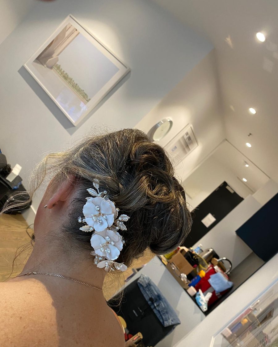 Bridal updo finished with white flowers