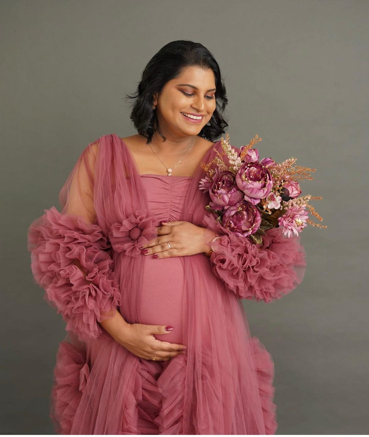 Client styled for a photoshoot in a pink gown