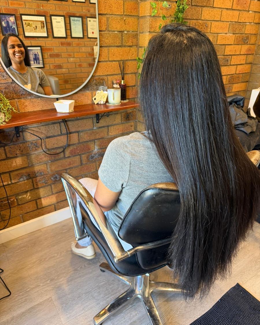 Long hair being finished in the salon chair