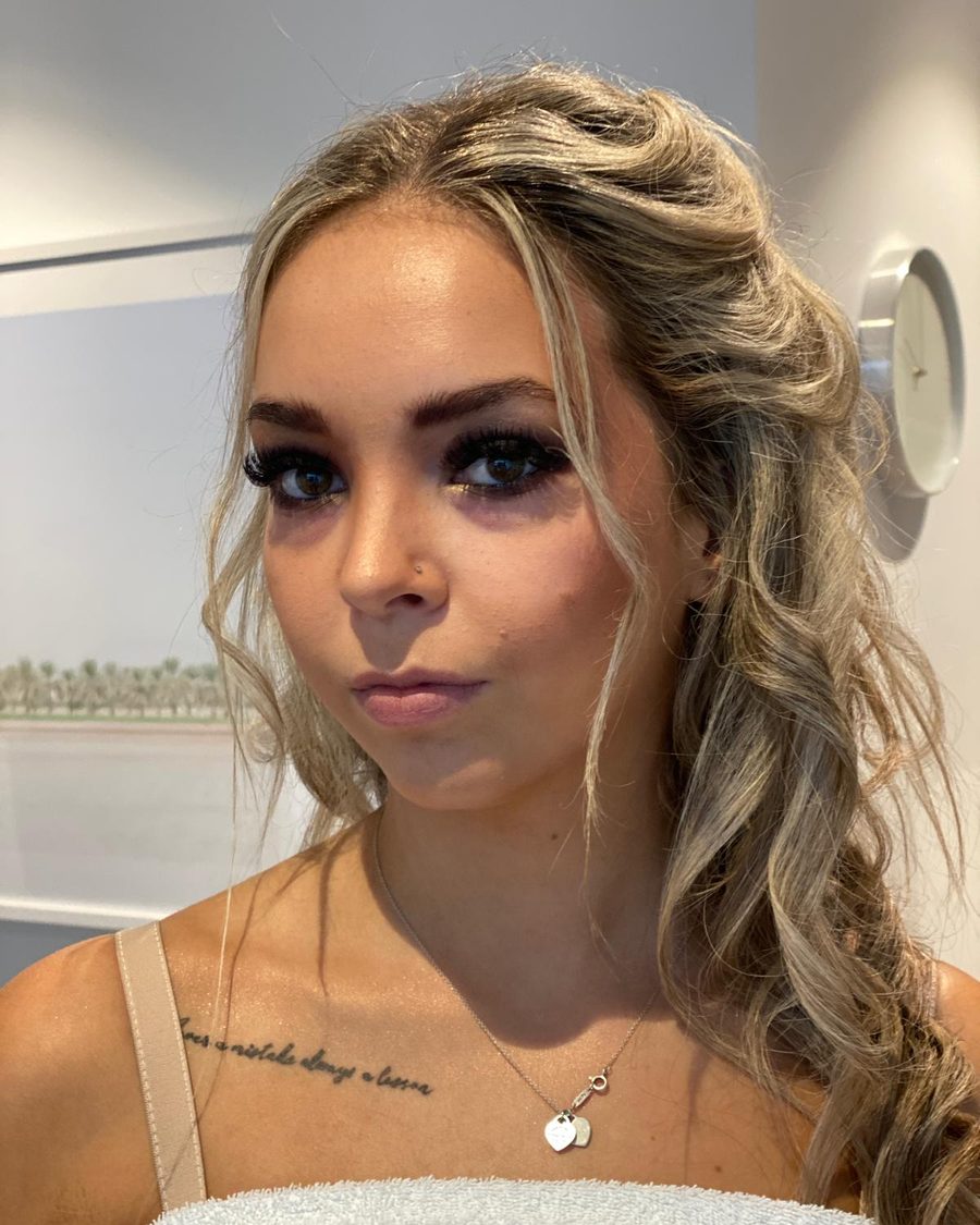 Soft glam makeup with loose waves